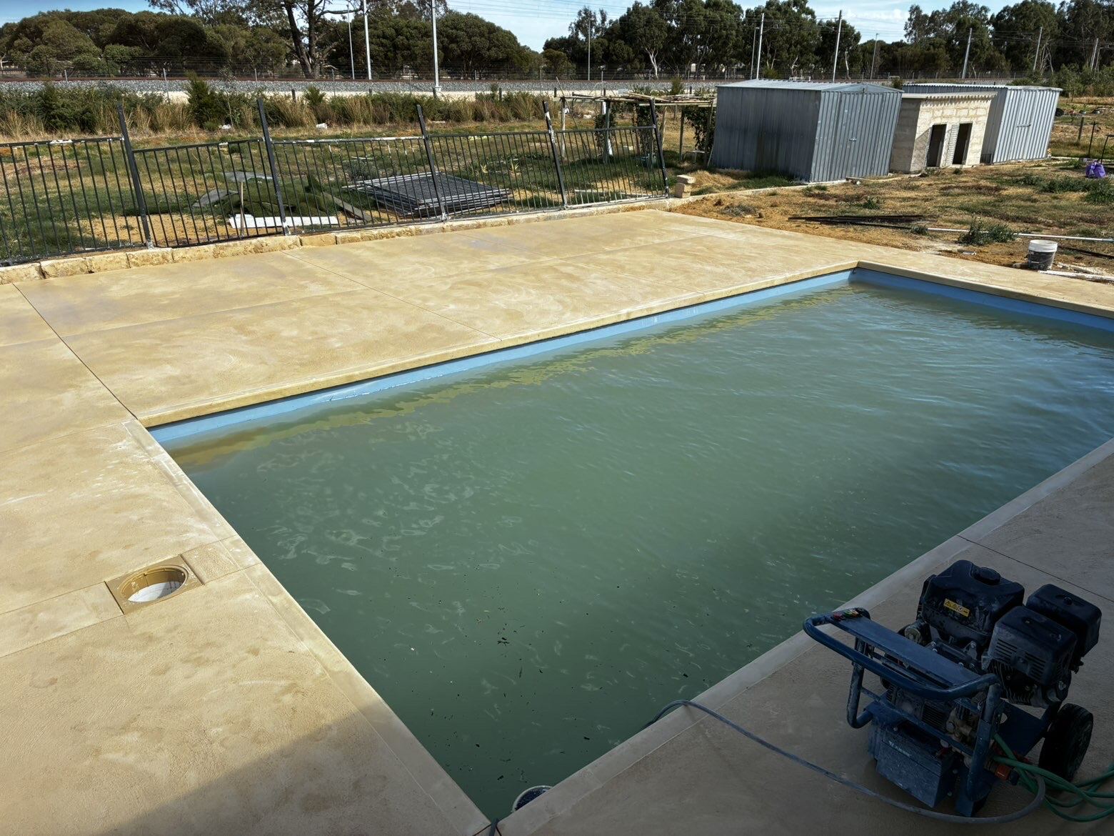 Coloured concrete pool surround
